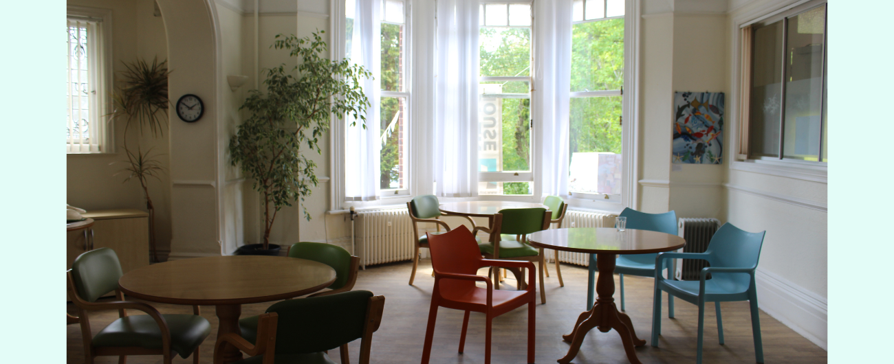 an image of staying well service room at wellbeing hub preston park, with chairs and tabled laid in an aesthetic, calming room